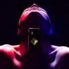 A man with his face covered by a cell phone.